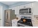 Bright kitchen featuring stainless steel appliances and white cabinetry at 6565 N 19Th Ave # 45, Phoenix, AZ 85015