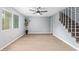 Living room with stairs, light colored walls and flooring, a window and decorations at 6565 N 19Th Ave # 45, Phoenix, AZ 85015