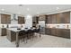 Modern kitchen with an expansive island, stainless steel appliances, ample cabinet space, and stylish pendant lighting at 7401 W Buckhorn Trl, Peoria, AZ 85383