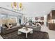 Stylish living room featuring modern lighting, neutral color palette, and seamless access to the outdoor living space at 7401 W Buckhorn Trl, Peoria, AZ 85383