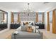 Beautiful main bedroom featuring stylish wallpaper, bedside tables, and a modern chandelier at 7401 W Buckhorn Trl, Peoria, AZ 85383