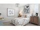 Charming bedroom with a patterned quilt, decorative wall art, and stylish side tables with lamps at 7404 W Buckhorn Trl, Peoria, AZ 85383