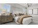 Bedroom with a cozy bed, stylish side tables, neutral decor, and plantation shutters for ample natural light at 7404 W Buckhorn Trl, Peoria, AZ 85383