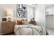 Cozy bedroom featuring stylish decor, with a love-themed wall art and modern bedside tables at 7404 W Buckhorn Trl, Peoria, AZ 85383