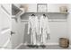 Bright walk-in closet featuring ample shelving, hanging rods, and a woven basket for storage solutions at 7404 W Buckhorn Trl, Peoria, AZ 85383