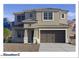 Two-story home with neutral color palette, tile roof, desert landscaping, and an attached two-car garage at 7404 W Buckhorn Trl, Peoria, AZ 85383