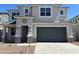 Charming two-story home featuring a gray stucco exterior, a two-car garage, and a well-manicured front yard at 7404 W Buckhorn Trl, Peoria, AZ 85383