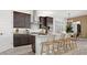 Modern kitchen featuring stainless steel appliances, a large island, and stylish counter seating at 7404 W Buckhorn Trl, Peoria, AZ 85383