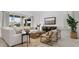Open-concept living room featuring stylish decor, a comfortable sofa, and a large window at 7404 W Buckhorn Trl, Peoria, AZ 85383