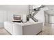 Bright living room with high ceilings, white shiplap, an entertainment center, and staircase at 7404 W Buckhorn Trl, Peoria, AZ 85383