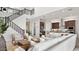 Open-concept living area connecting a modern staircase, kitchen, and comfortable seating at 7404 W Buckhorn Trl, Peoria, AZ 85383