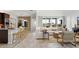 Open concept living room and kitchen featuring bar seating, wood-look floors, and modern furnishings at 7404 W Buckhorn Trl, Peoria, AZ 85383