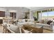 Spacious living room adjacent to kitchen with natural light and inviting decor at 7404 W Buckhorn Trl, Peoria, AZ 85383