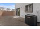 Backyard featuring a Goodman AC unit, sliding glass door access, and gravel landscaping at 7430 S 75Th Dr, Laveen, AZ 85339