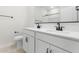 Modern bathroom featuring dual vanities with white countertops and sleek black fixtures, offering ample space at 7430 S 75Th Dr, Laveen, AZ 85339