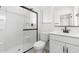 Well-lit bathroom featuring a glass-enclosed shower and a modern vanity, designed for comfort and style at 7430 S 75Th Dr, Laveen, AZ 85339
