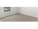 An empty bedroom with neutral carpet and a window allowing natural light, awaiting your personal touch at 7430 S 75Th Dr, Laveen, AZ 85339