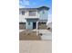 Charming townhome with a light blue accent, a well-kept lawn, and an attached garage at 7430 S 75Th Dr, Laveen, AZ 85339