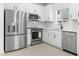 Modern kitchen with stainless steel appliances, white cabinets, and a subway tile backsplash at 7430 S 75Th Dr, Laveen, AZ 85339