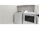 Modern laundry room features white, front-loading washer and dryer set at 7430 S 75Th Dr, Laveen, AZ 85339