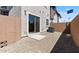 Low-maintenance backyard with gravel landscaping, block walls and a sliding glass door at 7437 S 75Th Dr, Laveen, AZ 85339
