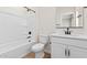 Bright bathroom with white tub, toilet, vanity, and matte black fixtures at 7437 S 75Th Dr, Laveen, AZ 85339