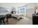 Comfortable bedroom with a work space bathed in natural light featuring cool blue and grey tones at 7437 S 75Th Dr, Laveen, AZ 85339