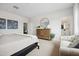 Neutral bedroom featuring a dresser with mirror, comfortable sitting area, and ensuite bathroom for convenience at 7437 S 75Th Dr, Laveen, AZ 85339