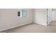 Bright bedroom with neutral carpet, window view, and access to the hallway and closet at 7437 S 75Th Dr, Laveen, AZ 85339
