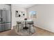 Bright dining area with modern table, seating, and stainless steel refrigerator at 7437 S 75Th Dr, Laveen, AZ 85339