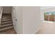 Hallway featuring the stairway, wood-look flooring, and sliding door to the outdoor patio at 7437 S 75Th Dr, Laveen, AZ 85339