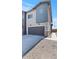 Modern two-story home with a gray stucco facade, two-car garage, and desert landscaping at 7437 S 75Th Dr, Laveen, AZ 85339