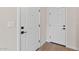 Entryway with clean white doors, black hardware, and light-colored flooring at 7437 S 75Th Dr, Laveen, AZ 85339