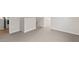 Hallway with neutral carpet and access to laundry area and additional bedrooms at 7437 S 75Th Dr, Laveen, AZ 85339