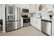 Modern kitchen with stainless steel appliances, white cabinets, countertops, and tile flooring at 7437 S 75Th Dr, Laveen, AZ 85339