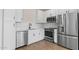 Close-up of kitchen with stainless steel appliances, white cabinets, and subway tile backsplash at 7437 S 75Th Dr, Laveen, AZ 85339