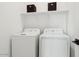 Bright laundry room featuring a white washer and dryer set for efficient and convenient laundry care at 7437 S 75Th Dr, Laveen, AZ 85339