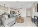 Spacious living area with stylish seating, tile floors, and seamless access to the kitchen at 7437 S 75Th Dr, Laveen, AZ 85339