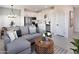 Open-concept living area connects to the kitchen with comfortable seating, tile floors, and modern decor at 7437 S 75Th Dr, Laveen, AZ 85339