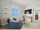 Inviting sitting room with views, comfortable blue chairs, and a modern aesthetic at 7437 S 75Th Dr, Laveen, AZ 85339