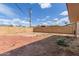 Backyard features a block wall fence, red rock ground cover, and potential for customization at 8033 N 56Th Ave, Glendale, AZ 85302