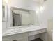 Bathroom vanity with white countertop, large mirror, and sink with silver hardware at 8033 N 56Th Ave, Glendale, AZ 85302