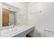 Bathroom vanity with white countertop, large mirror, and sink with silver hardware at 8033 N 56Th Ave, Glendale, AZ 85302