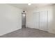 A bedroom with gray wood-look tile floors, white walls, and a closet with sliding doors at 8033 N 56Th Ave, Glendale, AZ 85302