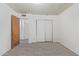 A bedroom with gray wood-look tile floors, white walls, and a closet with sliding doors at 8033 N 56Th Ave, Glendale, AZ 85302