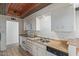 Traditional kitchen with wood-look countertops, white appliances, cabinets, and tile flooring at 8033 N 56Th Ave, Glendale, AZ 85302