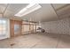 An empty room with a skylight, door to the outside, plywood walls, and wood shelving at 8033 N 56Th Ave, Glendale, AZ 85302