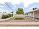 Spacious backyard featuring turf and stone landscaping, a patio, and privacy walls at 8334 E Palm Ln, Scottsdale, AZ 85257
