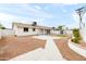 Spacious backyard featuring turf and stone landscaping, a patio, and a building at 8334 E Palm Ln, Scottsdale, AZ 85257