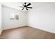 Bright bedroom featuring a ceiling fan, light-colored wood floors, and neutral paint at 8334 E Palm Ln, Scottsdale, AZ 85257